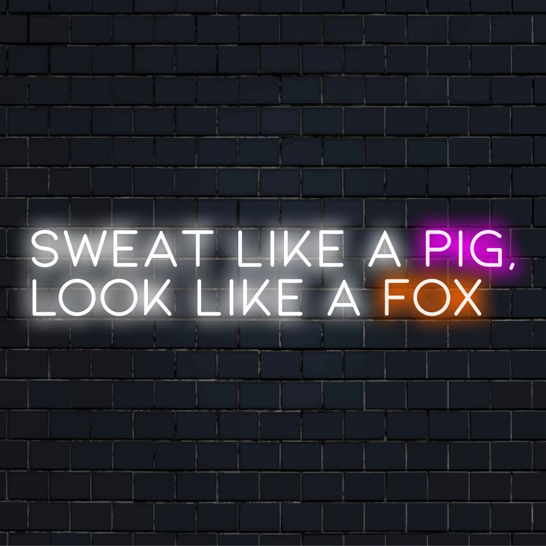 An LED neon sign with the text Sweat Like A Pig, Look Like A Fox, blending motivational art with stylish light decor.