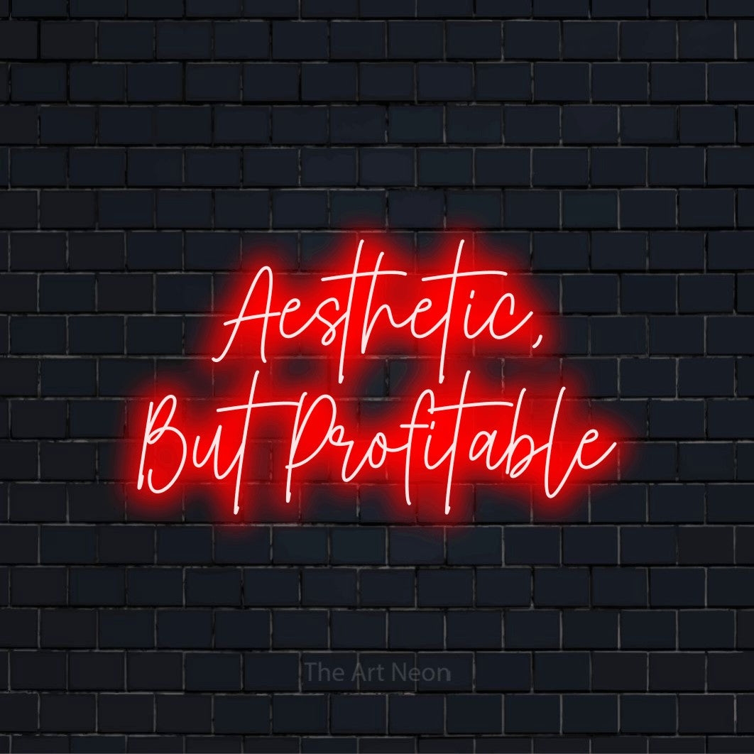 "Aesthetic, But Profitable" glowing LED neon sign on a black brick wall