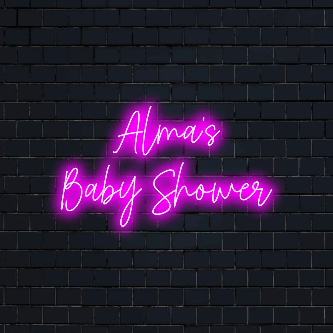 Alma_s Baby Shower Custom Name Neon Sign, neon text light on dark brick wall