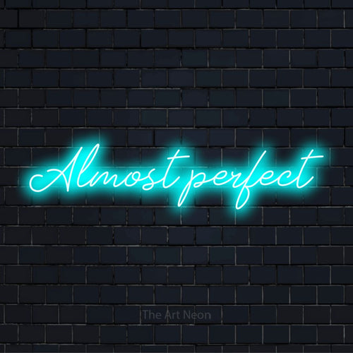"Almost Perfect" text design with neon effect on a black brick wall