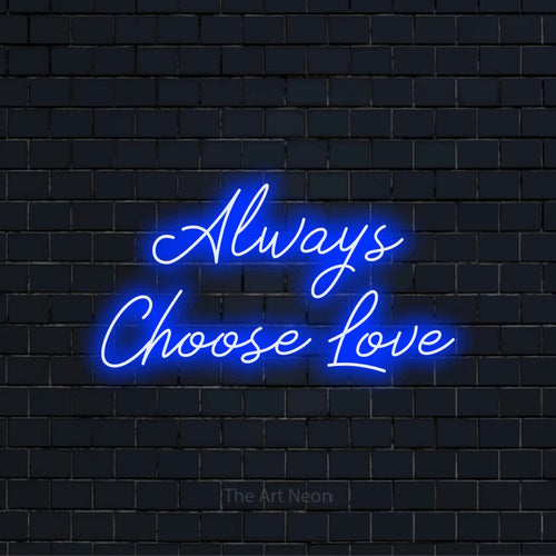 "Always Choose Love" glowing LED neon sign on a black brick wall