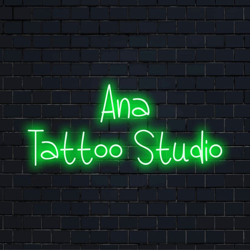 Ana Tattoo Studio Custom Name Neon Sign, bright neon lettering against brick backdrop
