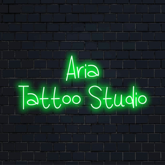 Aria Tattoo Studio Personalized Neon Light with glowing neon text against brick backdrop
