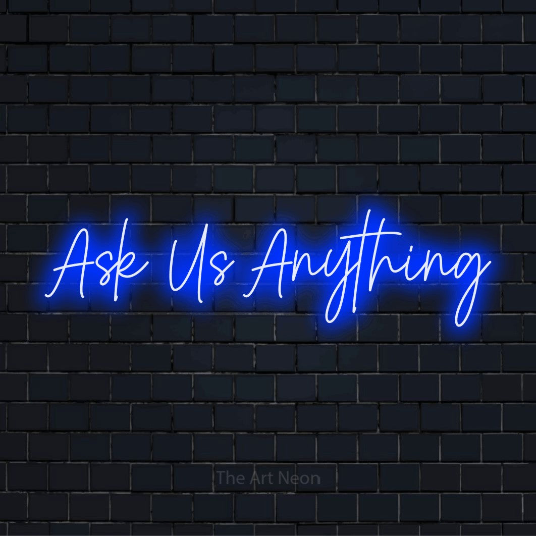 "Ask Us Anything" glowing LED neon sign on a black brick wall