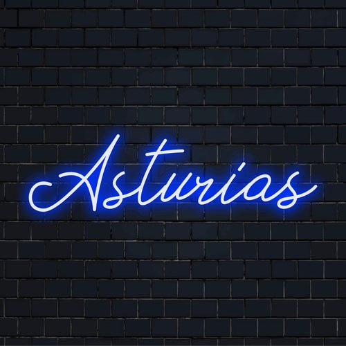 Asturias Neon Light with bright neon lettering against brick backdrop