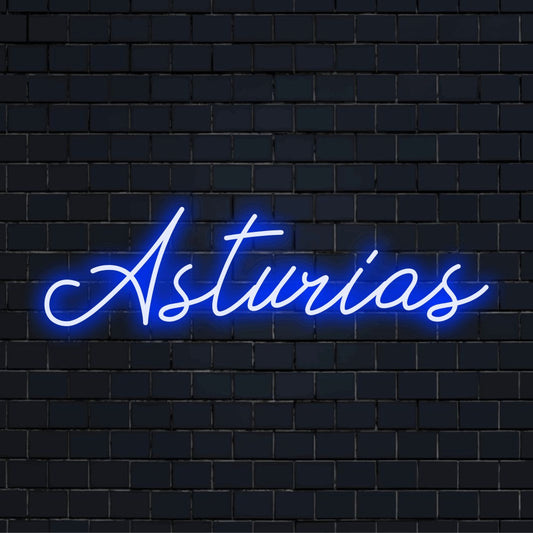 Asturias Neon Light with bright neon lettering against brick backdrop