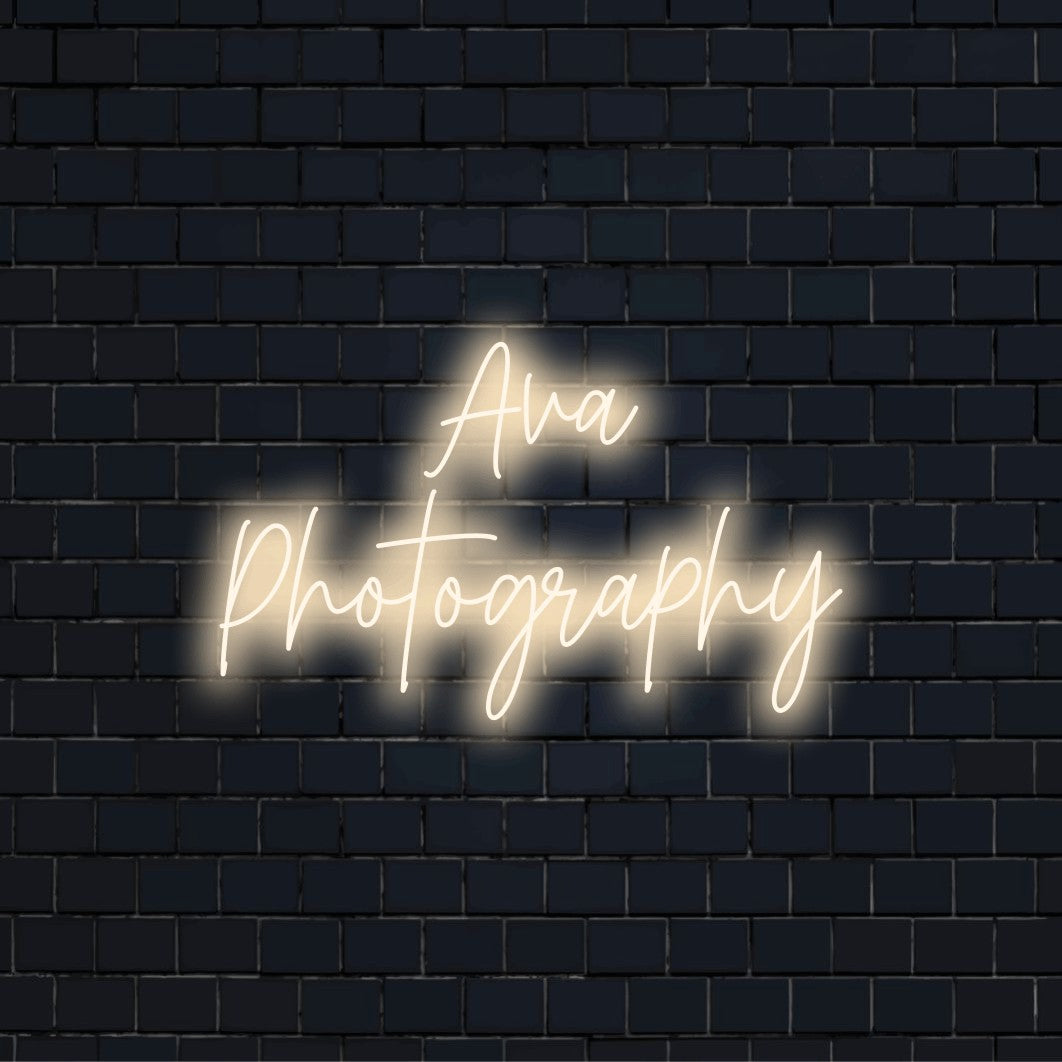 Ava Photography Personalized LED Neon Sign, bright neon glow on dark brick wall