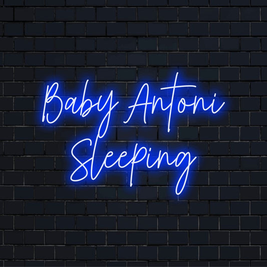 Baby Antoni Sleeping Custom Name Neon Sign, neon text light against black brick wall