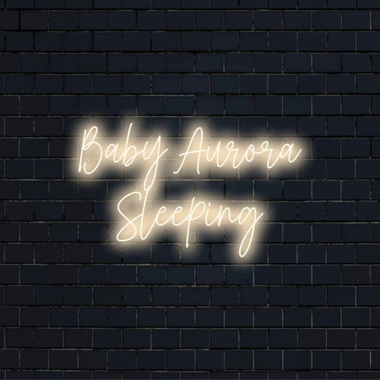Baby Aurora Sleeping Custom Name Neon Sign, bright neon lettering on black brick background