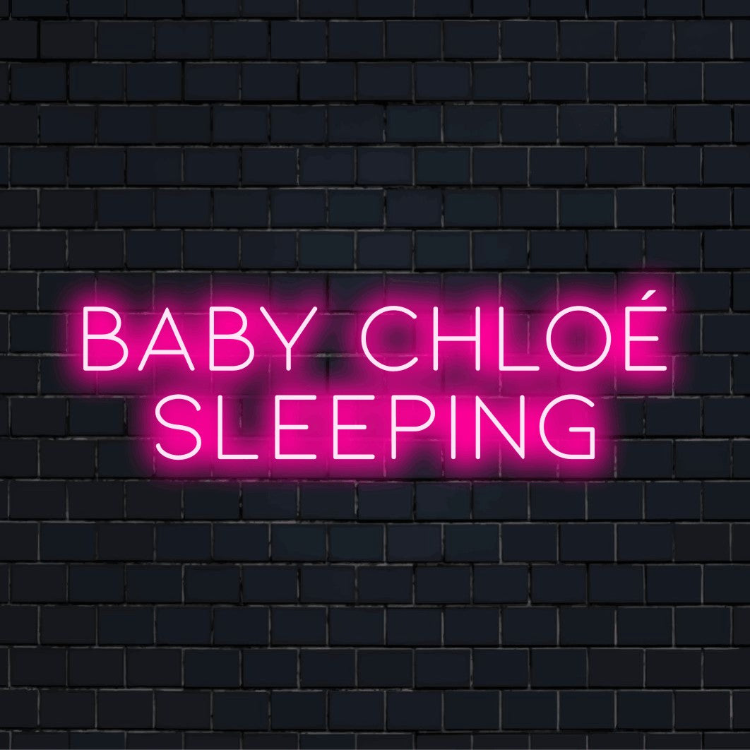 Baby Chloe Sleeping Personalized Neon Light with bright LED glow on dark brick wall