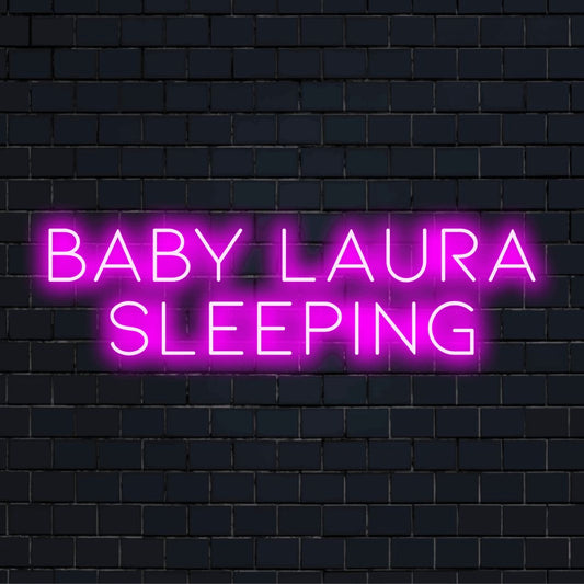 Baby Laura Sleeping Custom Name Neon Sign, glowing neon text against black brick wall