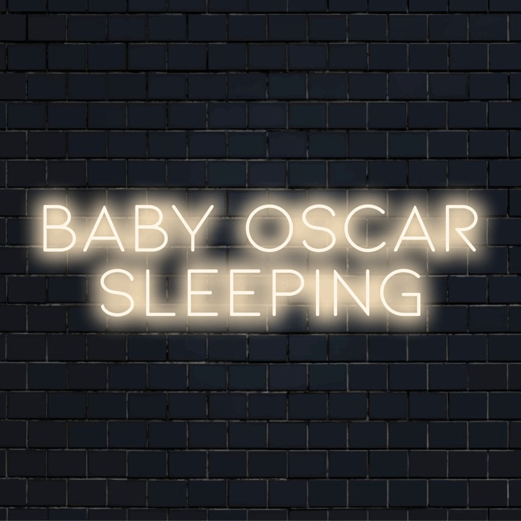 Baby Oscar Sleeping Custom Name Neon Sign, glowing wall decor against black brick wall