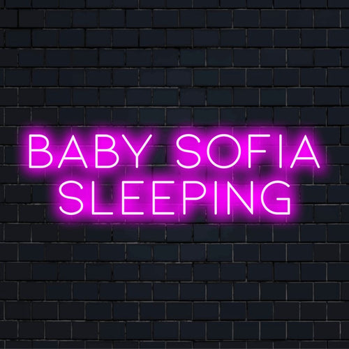 Baby Sofia Sleeping Custom Name Neon Sign, bright neon lettering on black brick background