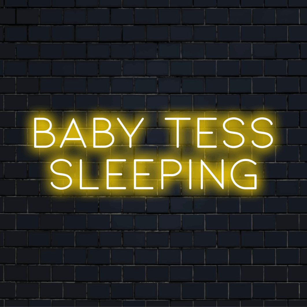 Baby Tess Sleeping Custom Name Neon Sign, glowing wall decor on dark brick wall