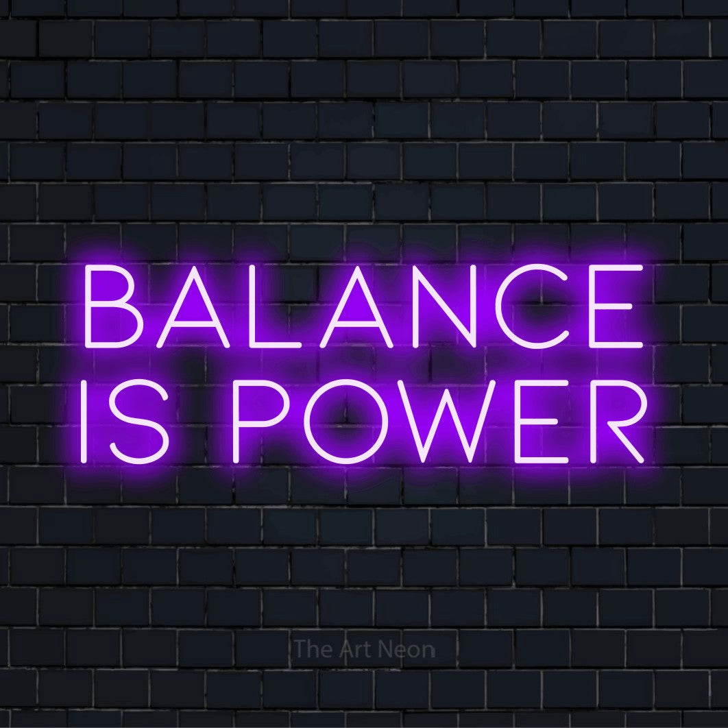 "Balance Is Power" text design with neon effect on a black brick wall