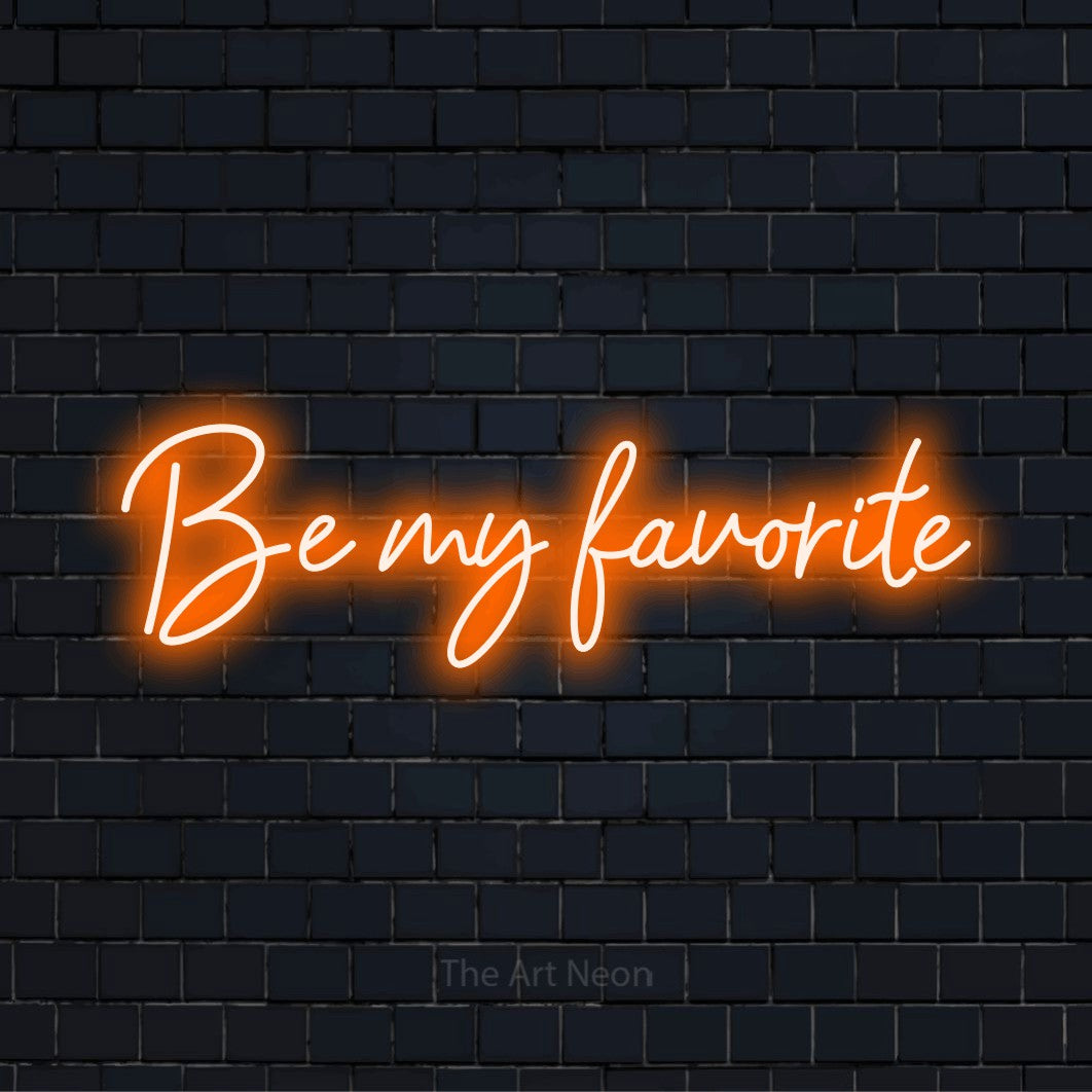 "Be My Favorite" neon text design on a black brick wall