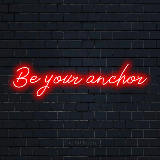 "Be Your Anchor" LED neon sign on a black brick wall