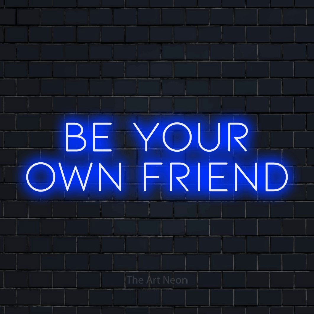 "Be Your Own Friend" neon text design on a black brick wall