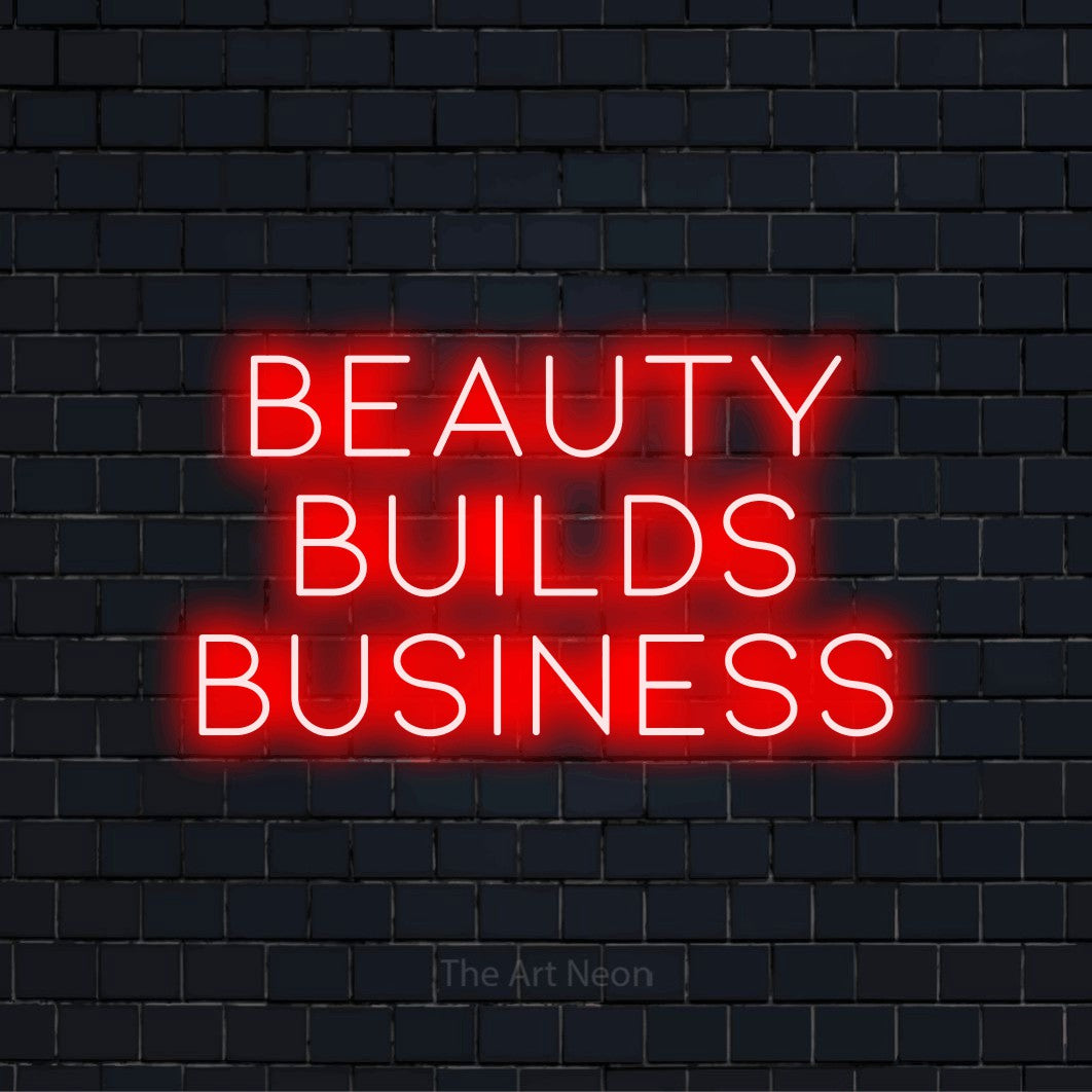 "Beauty Builds Business" LED neon sign on a black brick wall