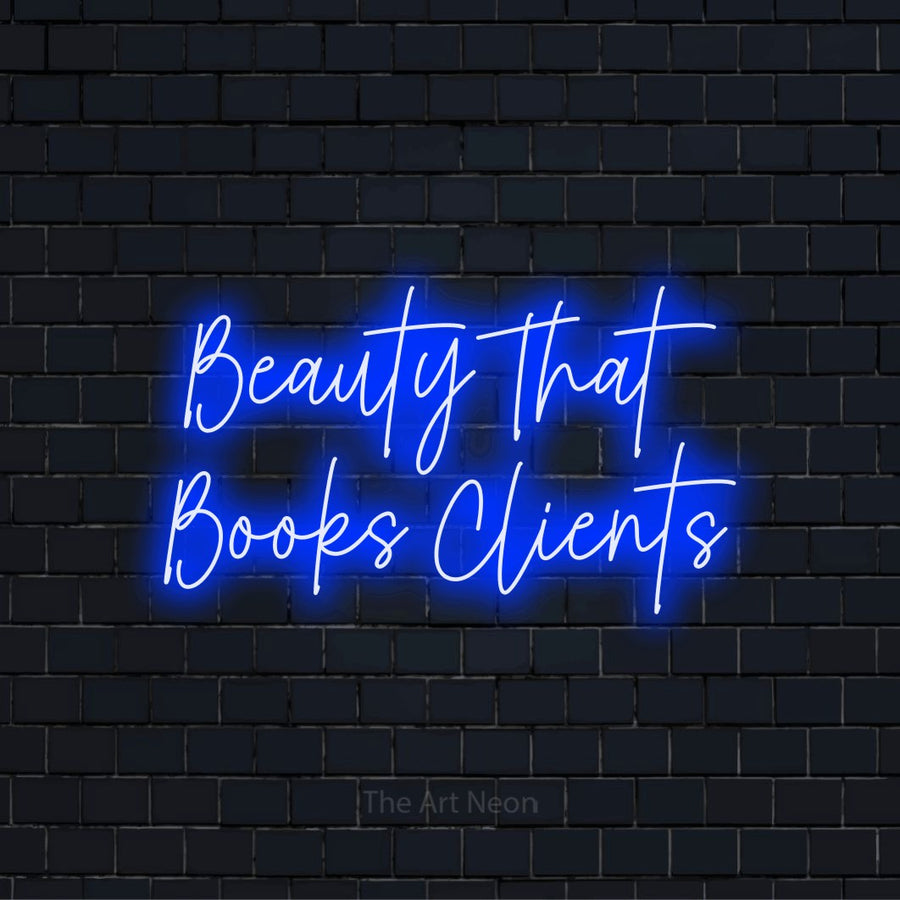 "Beauty That Books Clients" script-style LED neon sign on a black brick wall