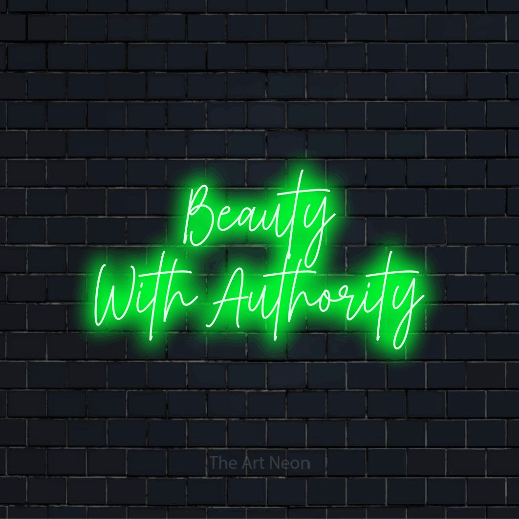 "Beauty With Authority" glowing LED neon sign on a black brick wall