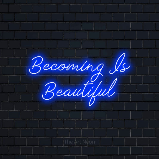 "Becoming Is Beautiful" neon text design on a black brick wall