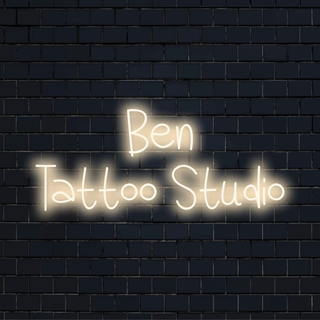 Ben Tattoo Studio Custom Name Neon Sign, glowing wall decor against black brick wall