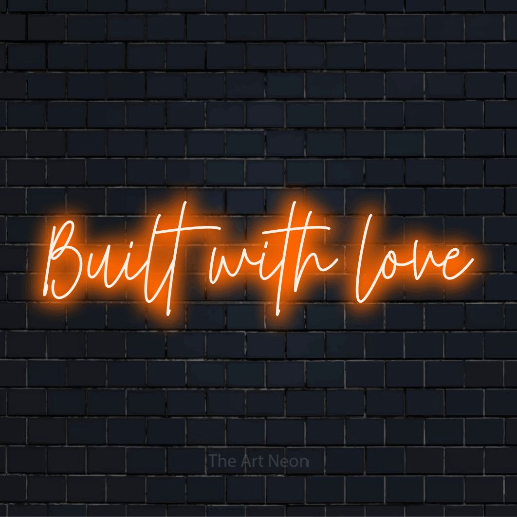 "Built With Love" LED neon sign on a black brick wall