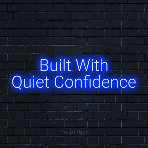"Built With Quiet Confidence" glowing LED neon sign on a black brick wall