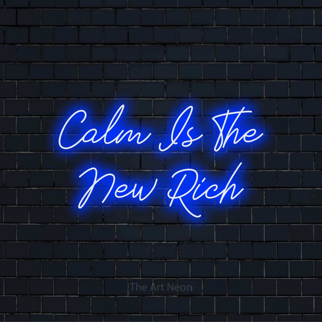 "Calm Is The New Rich" neon text design on a black brick wall