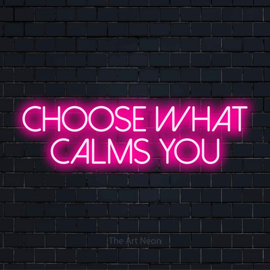 "Choose What Calms You" glowing LED neon sign on a black brick wall