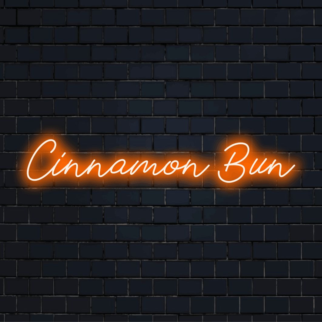 Cinnamon Bun Neon Sign, glowing lettering on black brick background