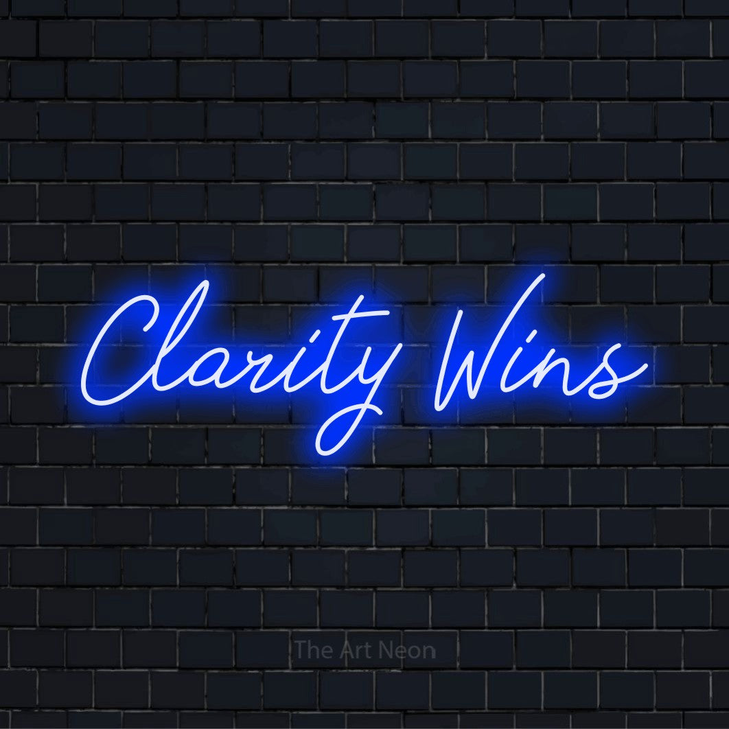 "Clarity Wins" LED neon sign on a black brick wall
