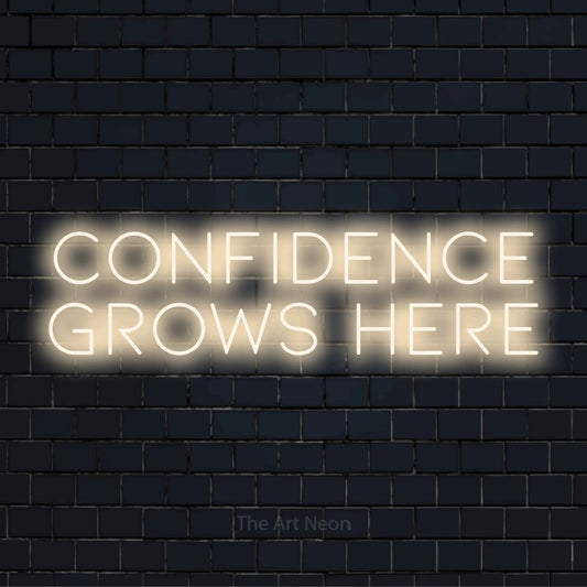 "Confidence Grows Here" neon text design on a black brick wall