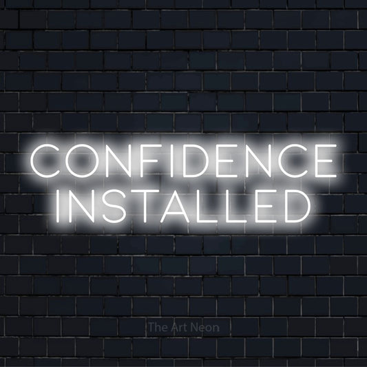 "Confidence Installed" LED neon sign on a black brick wall
