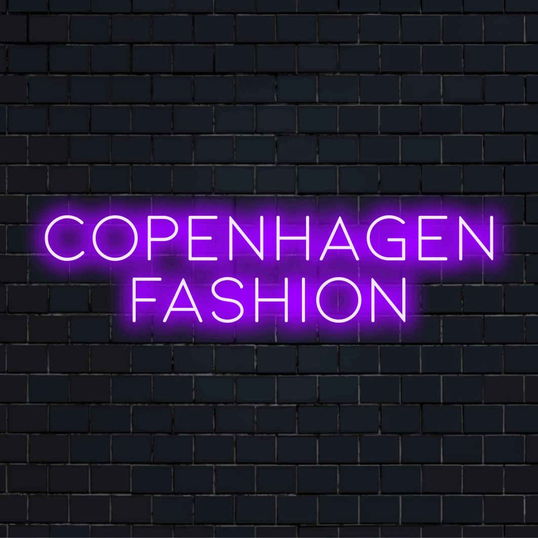 Copenhagen Fashion Neon Light with bright neon lettering on dark brick wall