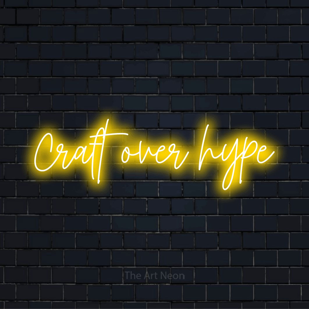 "Craft Over Hype" neon text design on a black brick wall