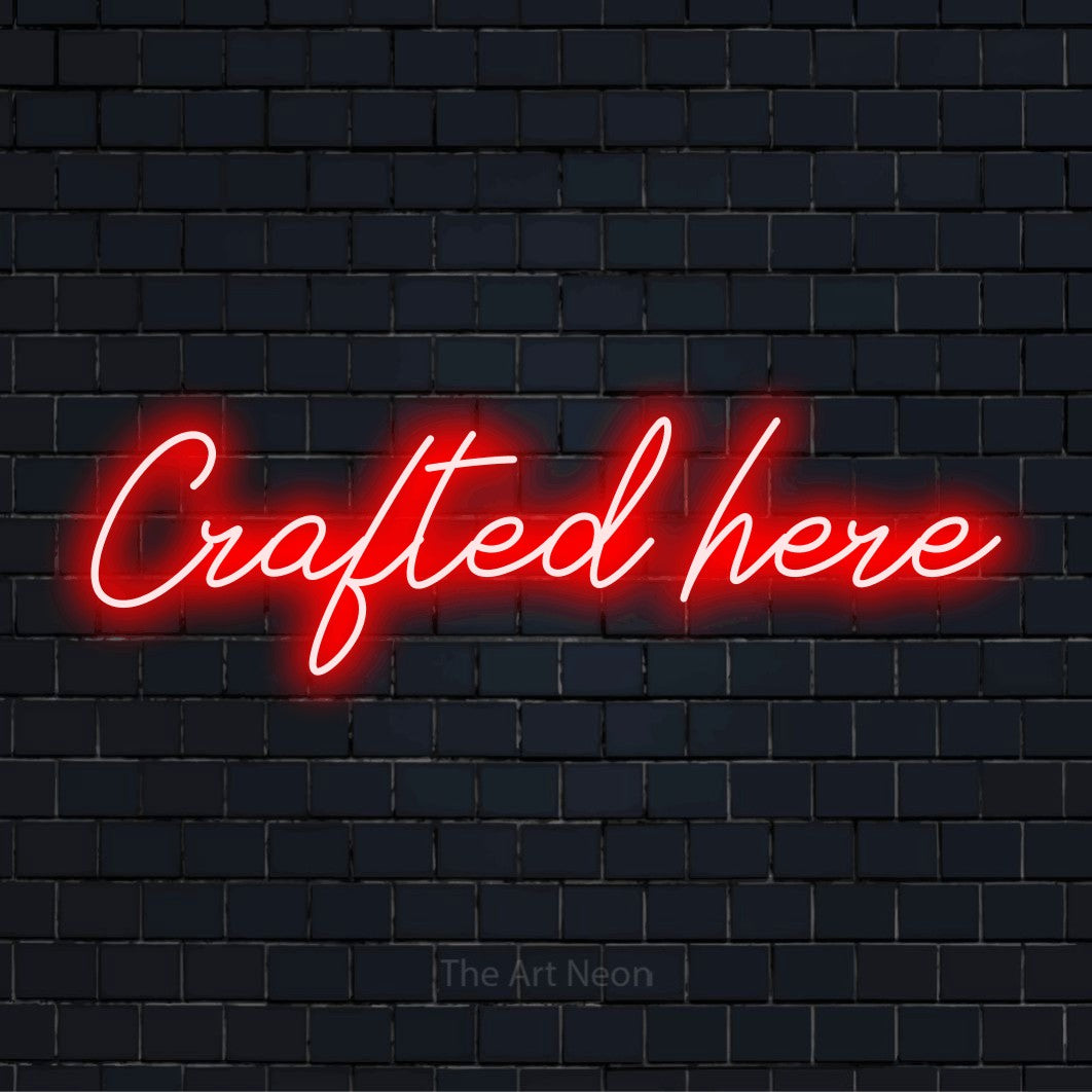 "Crafted Here" LED neon sign on a black brick wall