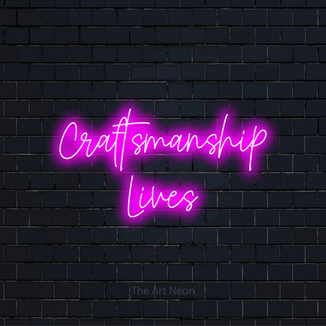 "Craftsmanship Lives" LED neon sign on a black brick wall