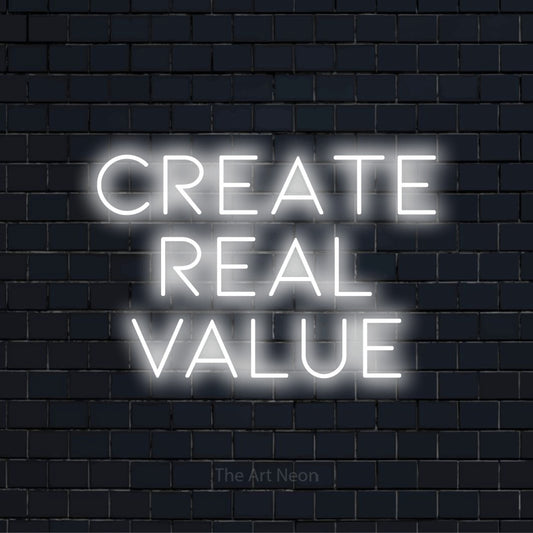 "Create Real Value" glowing LED neon sign on a black brick wall