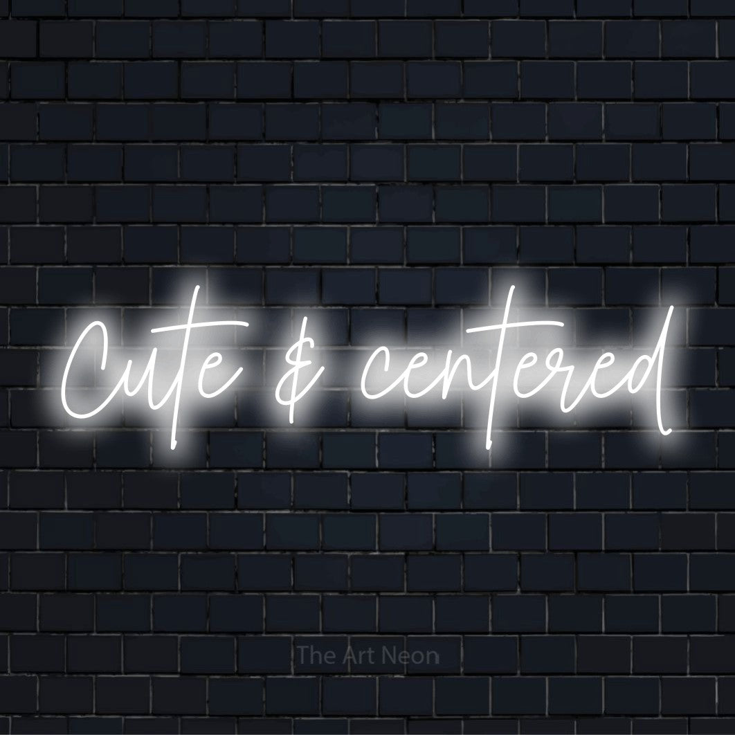 "Cute & Centered" glowing LED neon sign on a black brick wall
