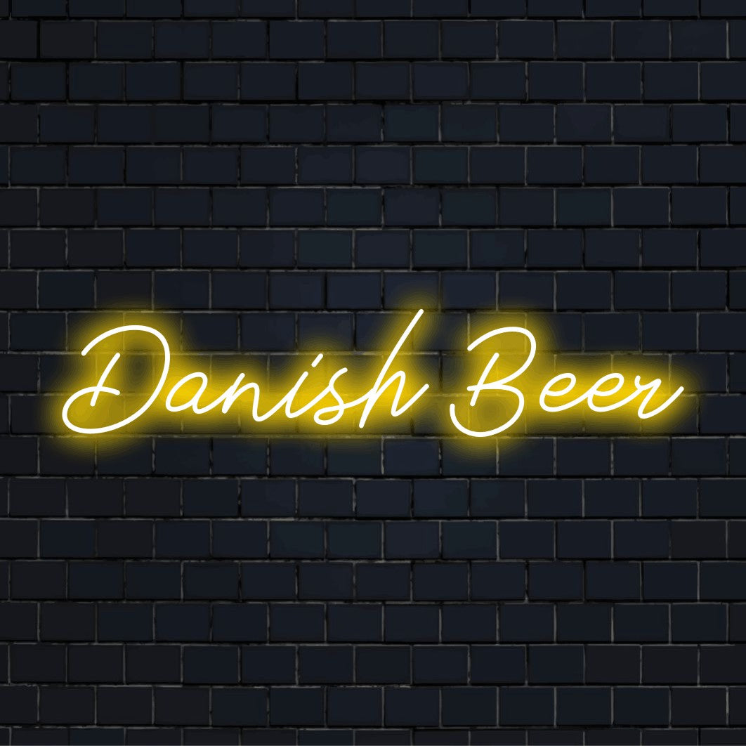 Danish Beer Neon Light with glowing neon text against black brick wall