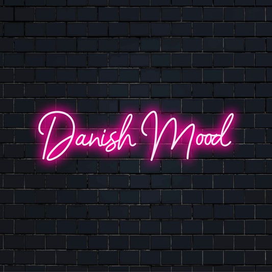 Danish Mood Neon Sign, bright neon lettering against brick backdrop