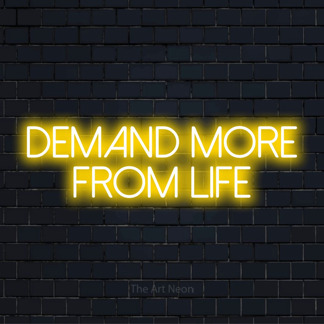 "Demand More From Life" neon text design on a black brick wall