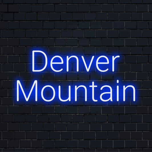 Denver Mountain Neon Light with glowing lettering against black brick wall