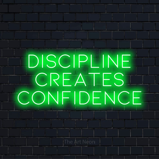 "Discipline Creates Confidence" LED neon sign on a black brick wall