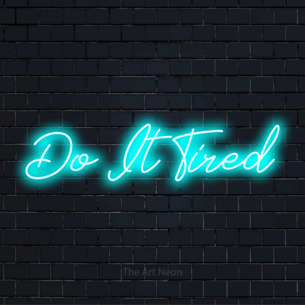 "Do It Tired" neon text design on a black brick wall