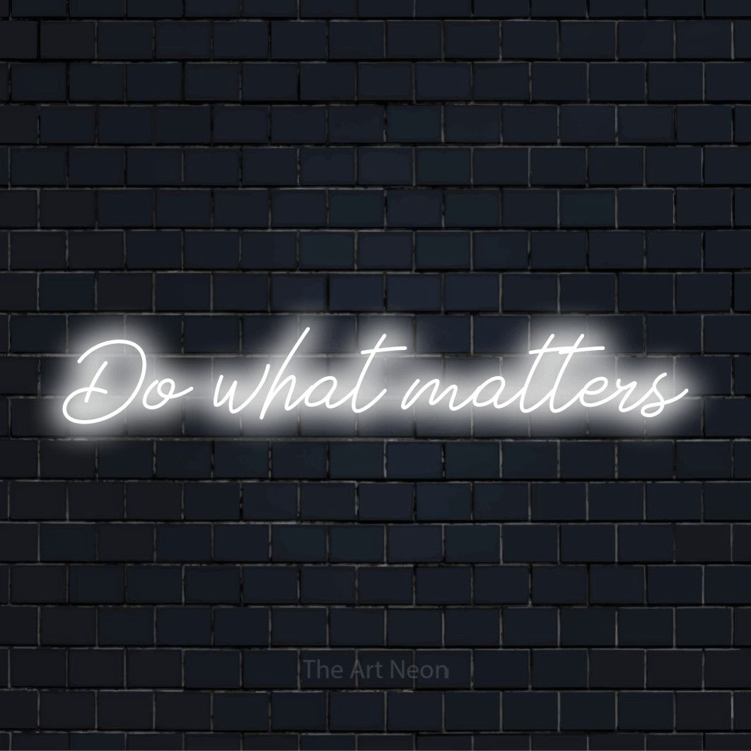 "Do What Matters" neon text design on a black brick wall