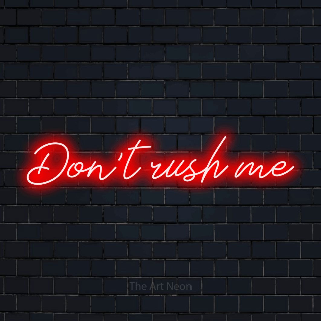 "Don’t Rush Me" LED neon sign on a black brick wall