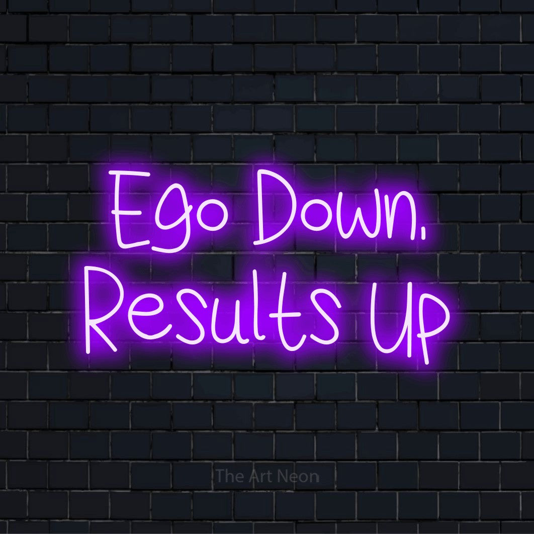 "Ego Down, Results Up" LED neon sign on a black brick wall